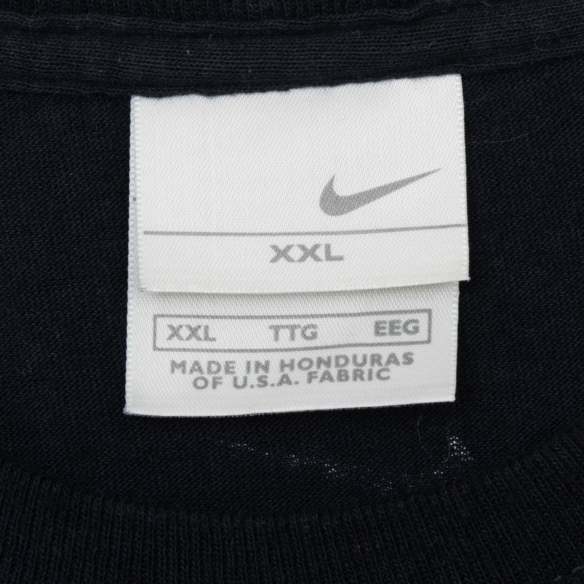 Close-up of Nike neck tag marked XXL on black tank top