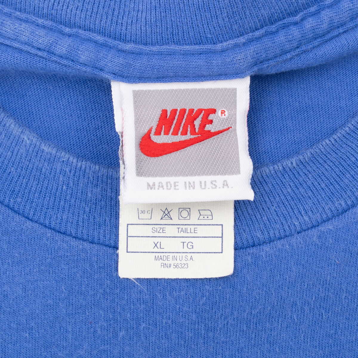 Nike neck tag showing size XL and Made in U.S.A. on blue T-shirt