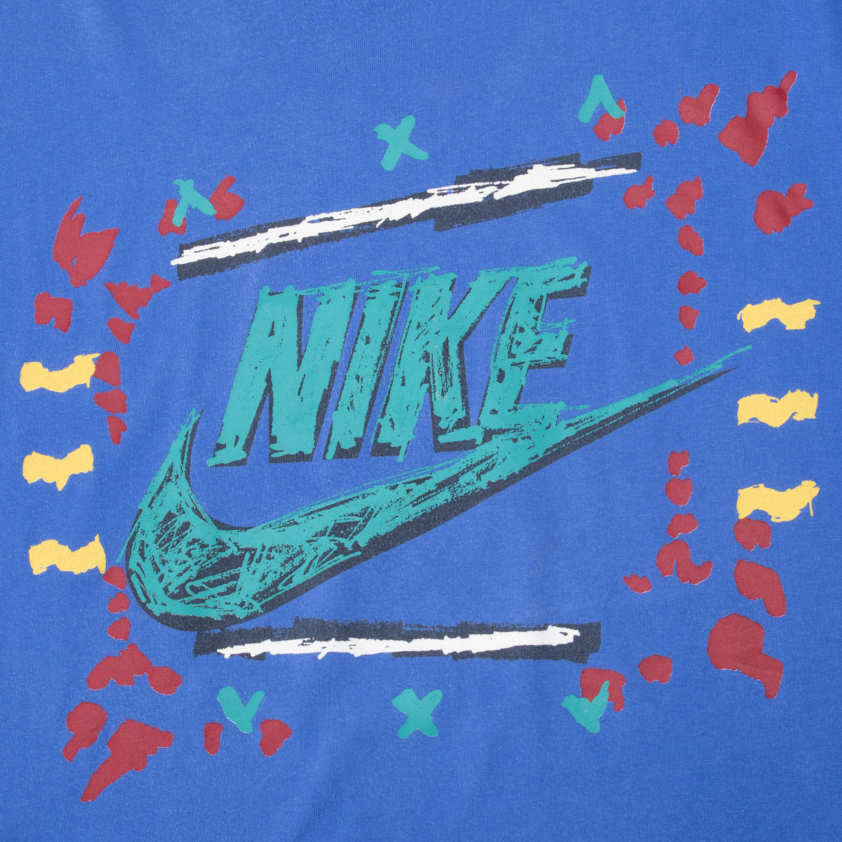 Close-up of teal Nike wordmark and Swoosh with red, yellow, black, and white abstract accents