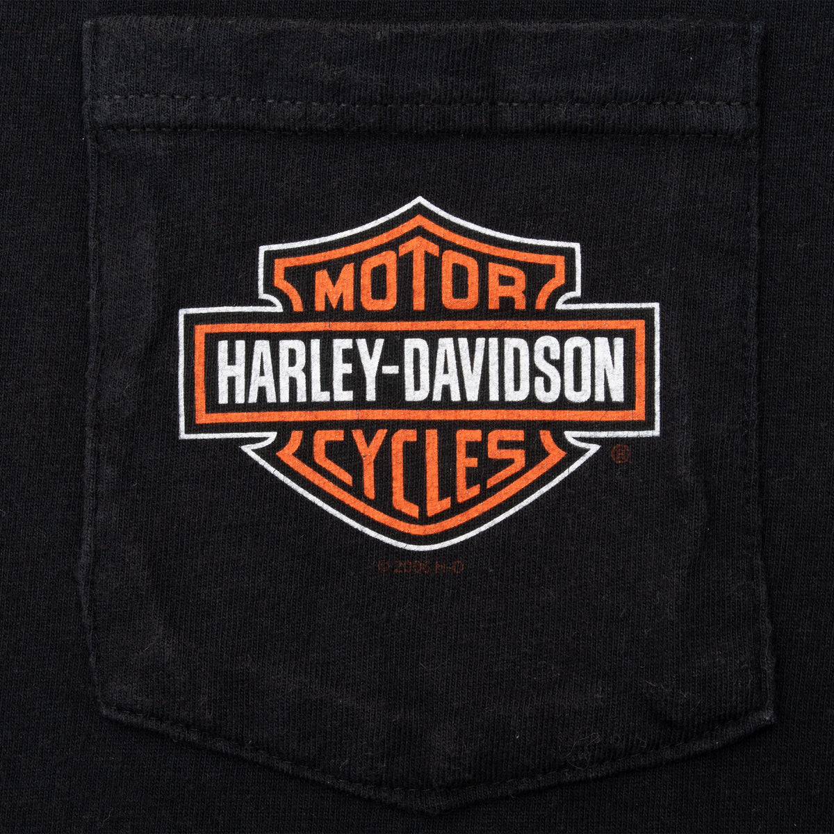 Close-up of Harley-Davidson shield logo printed on black chest pocket