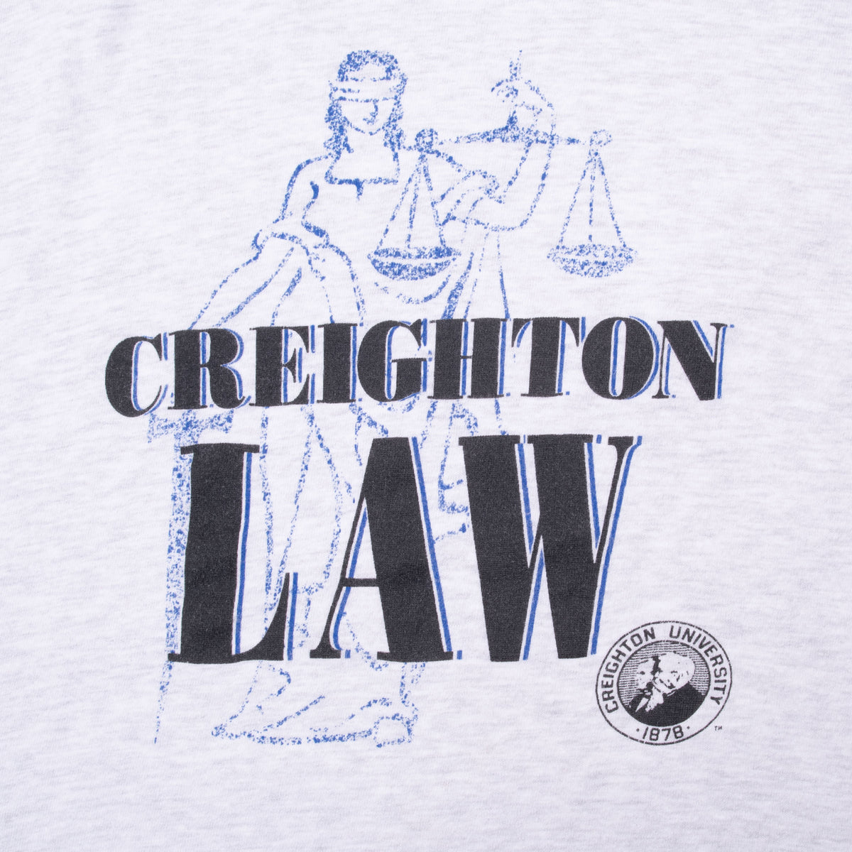Creighton Law print detail with Lady Justice illustration and Creighton University seal