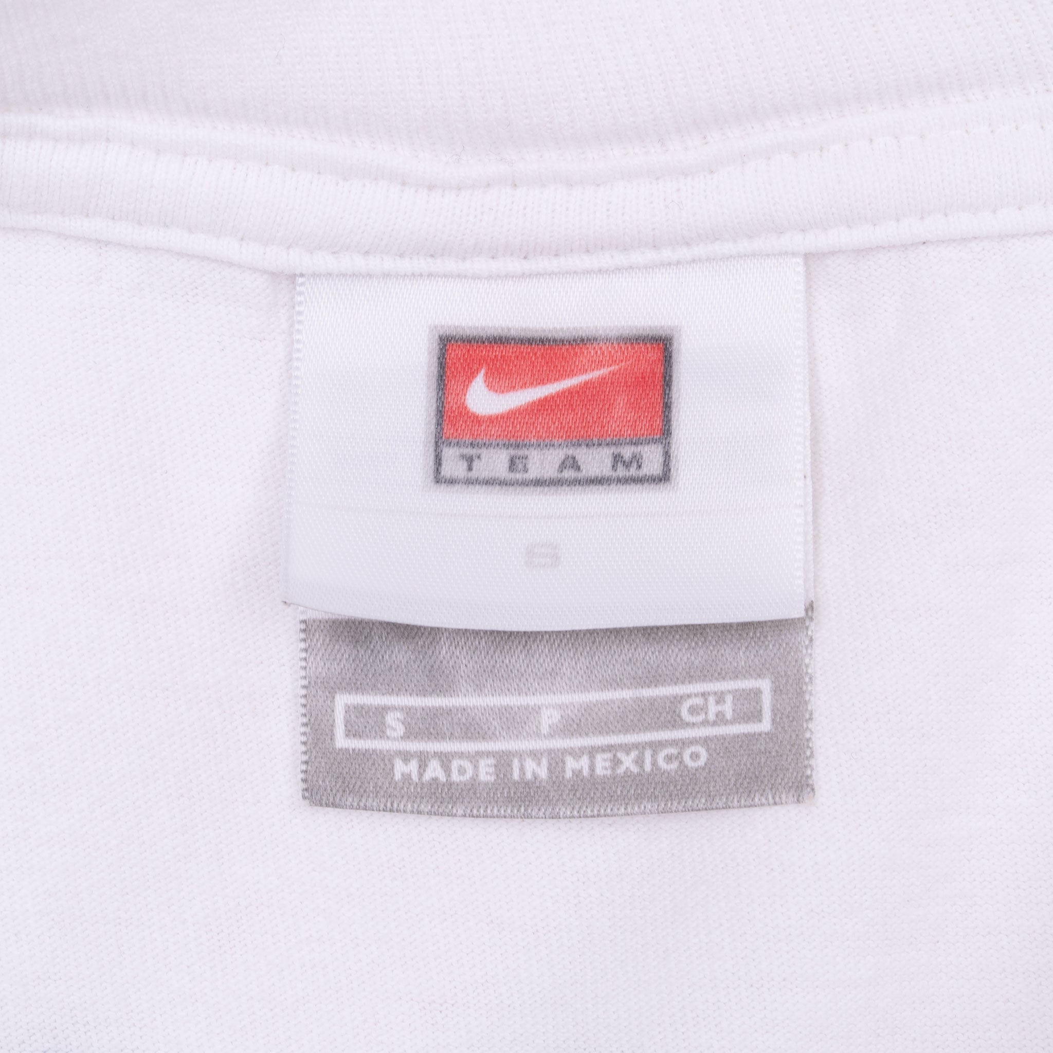 Nike Team neck tag showing size small on white T-shirt