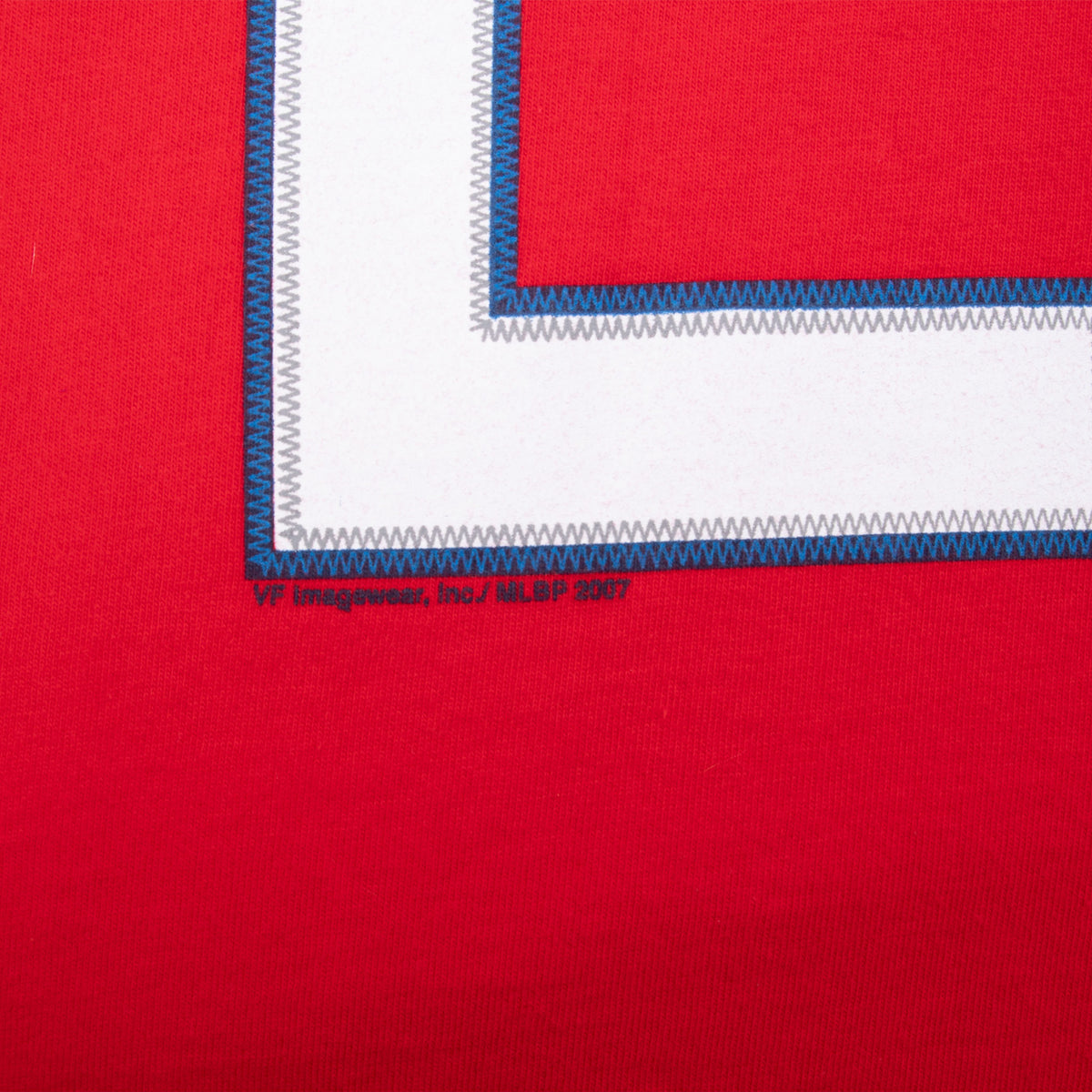 Close-up of number stitching and MLBPA 2007 copyright print on red fabric