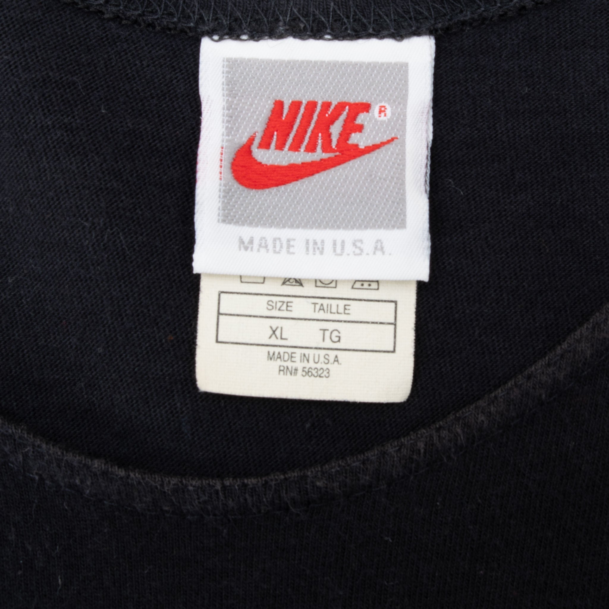 Nike neck and size tags marked XL and Made in U.S.A. on black tank top