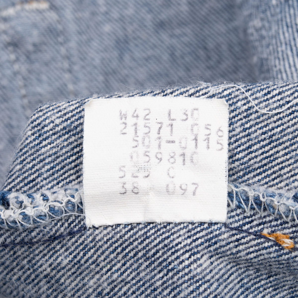 Close-up of interior Levi's 501 jeans label marked W42 L30 and 525