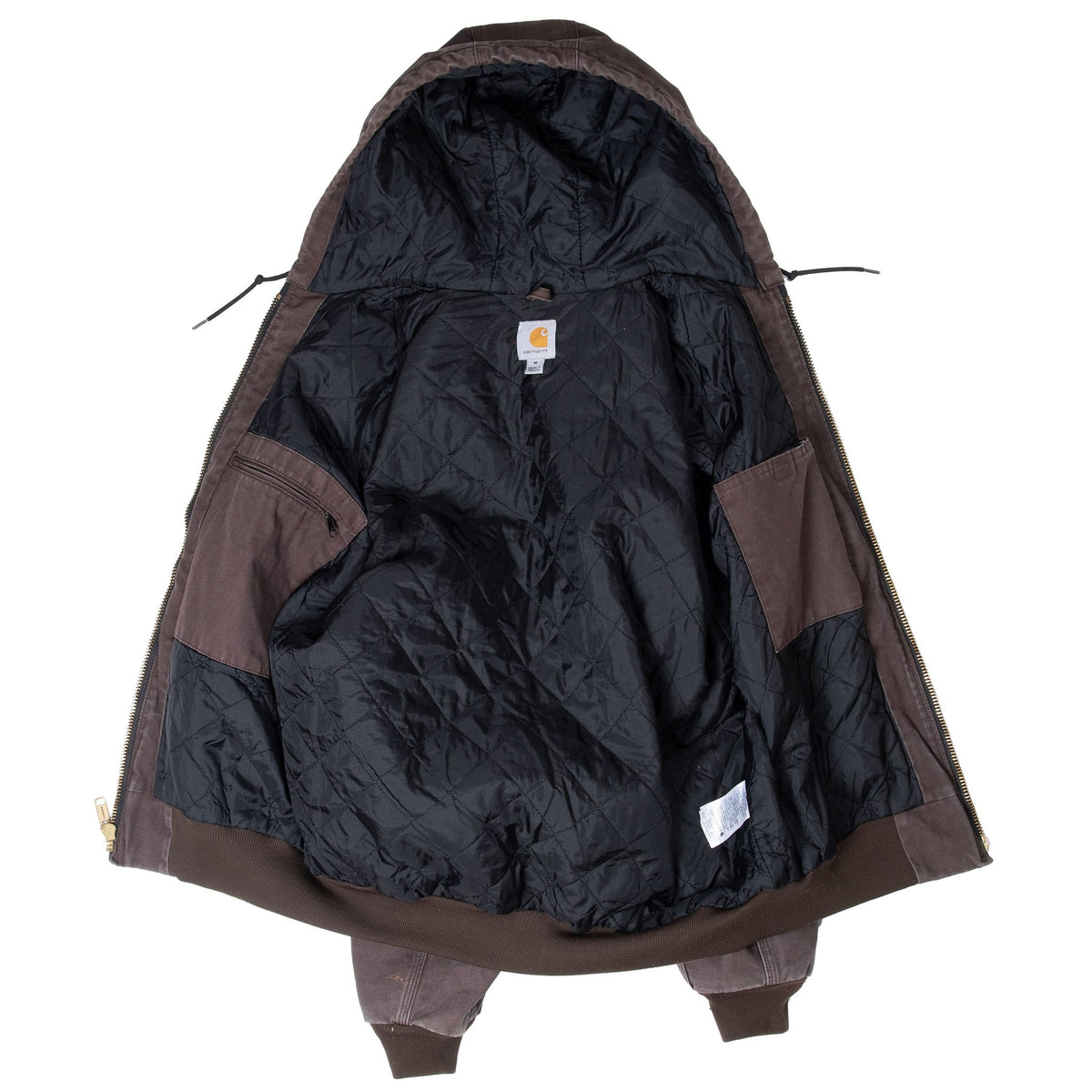 Open Carhartt jacket showing black quilted interior lining, hood and inner label