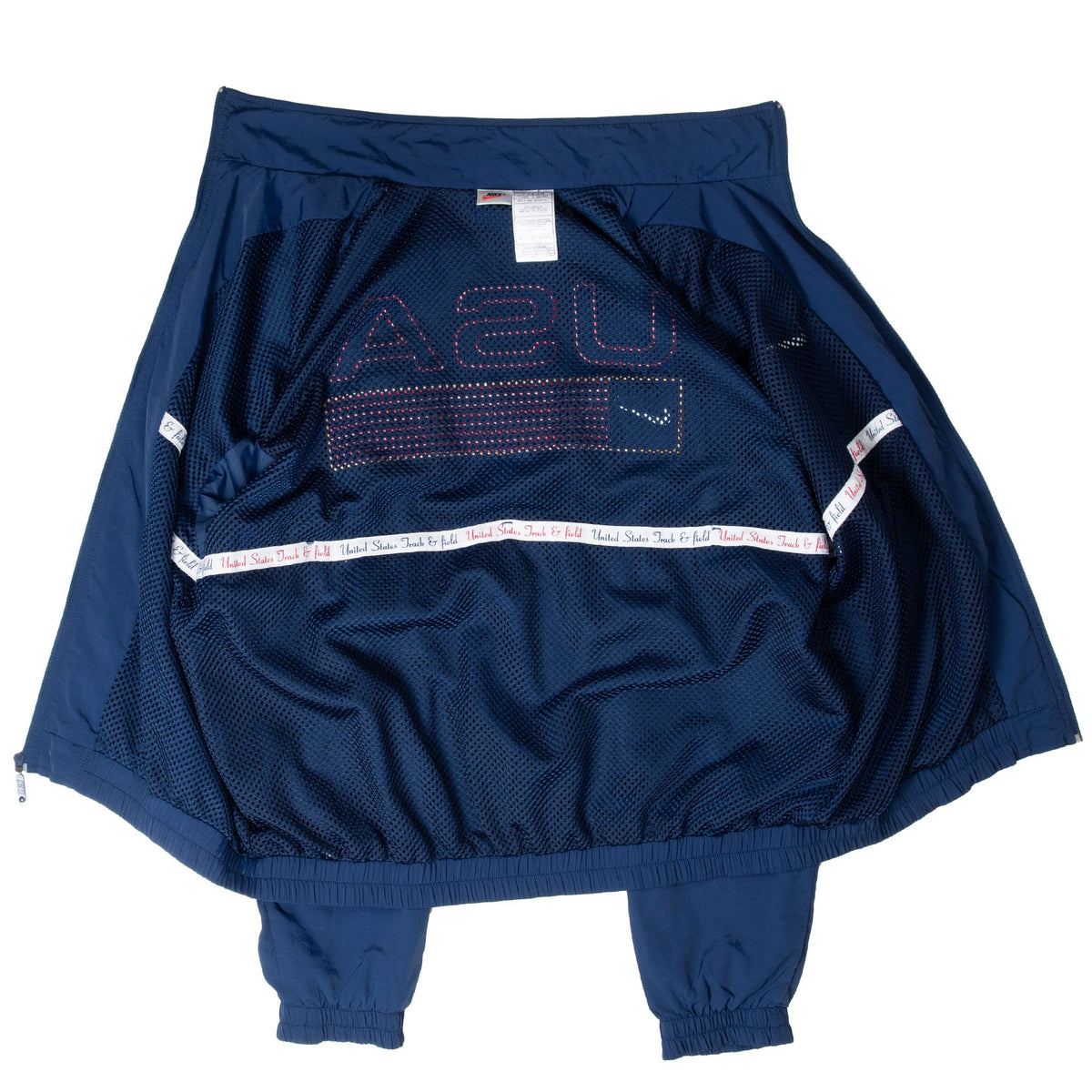 Open interior of Nike Team USA windbreaker showing mesh lining, labels, and reverse back graphic