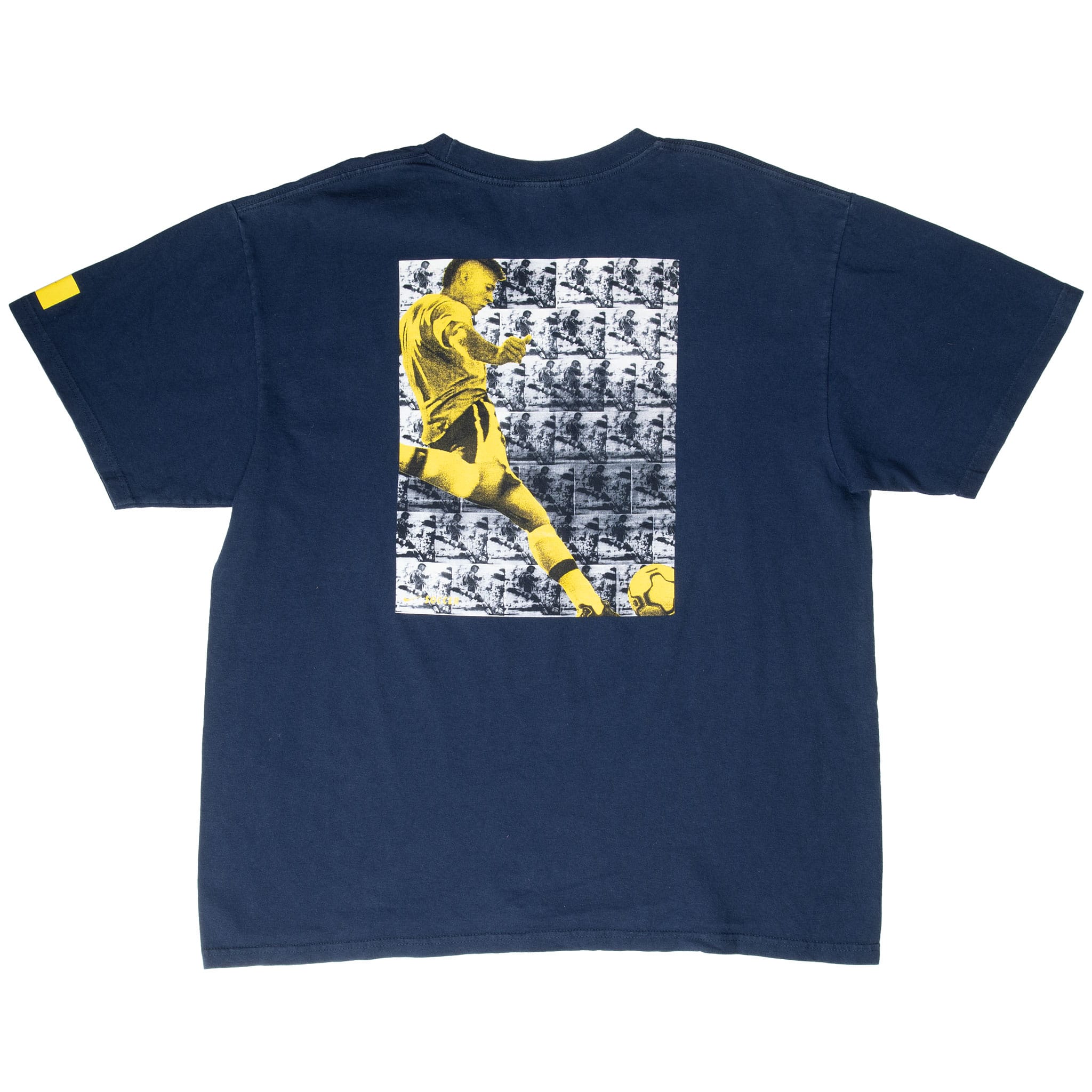 Back of navy Nike soccer T-shirt with large yellow, black, and white player graphic
