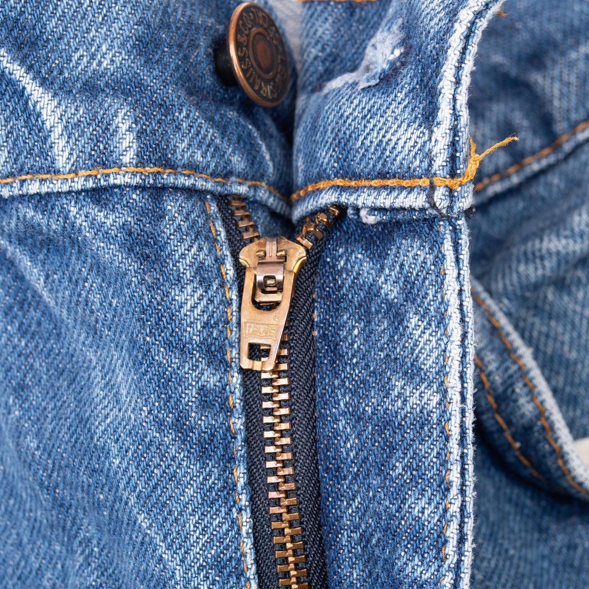 Close-up of the Levi's jeans metal zipper fly and waistband button