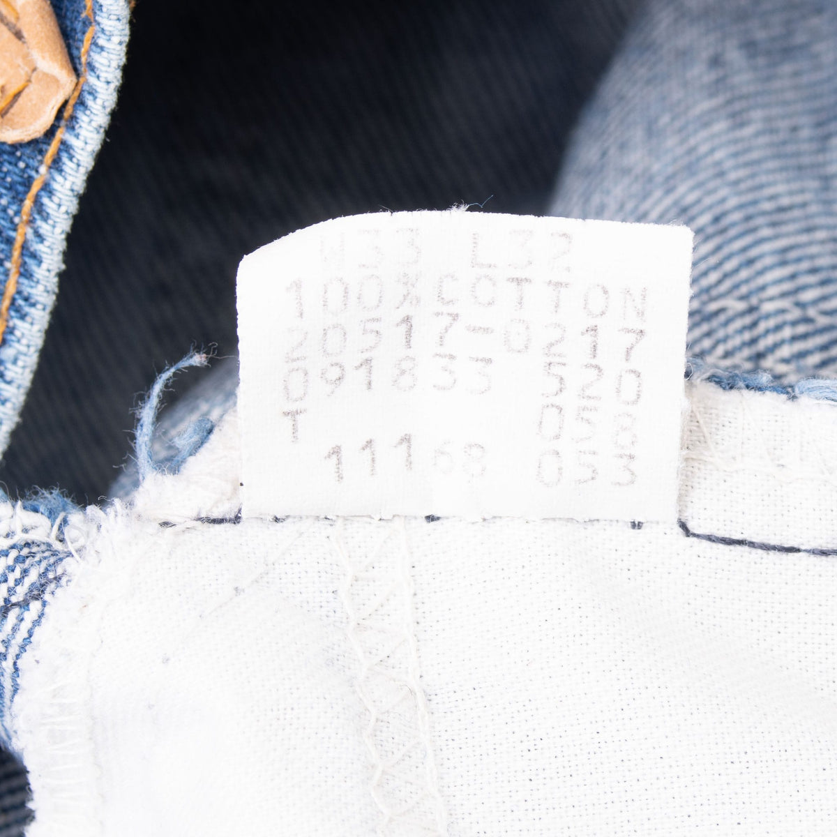 Close-up of the faded interior Levi's jeans content and production code tag