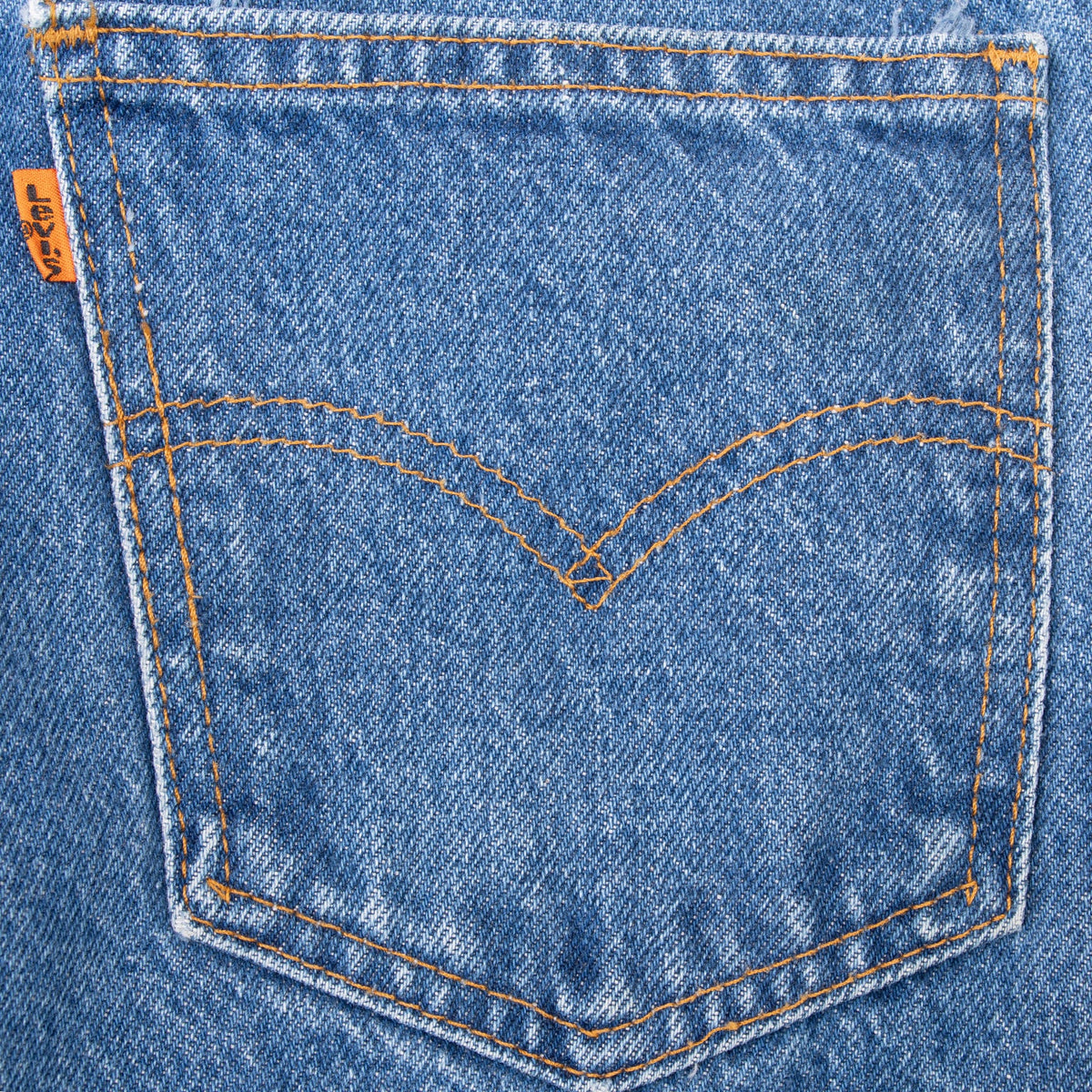 Close-up of a rear pocket with Levi's arcuate stitching and orange tab