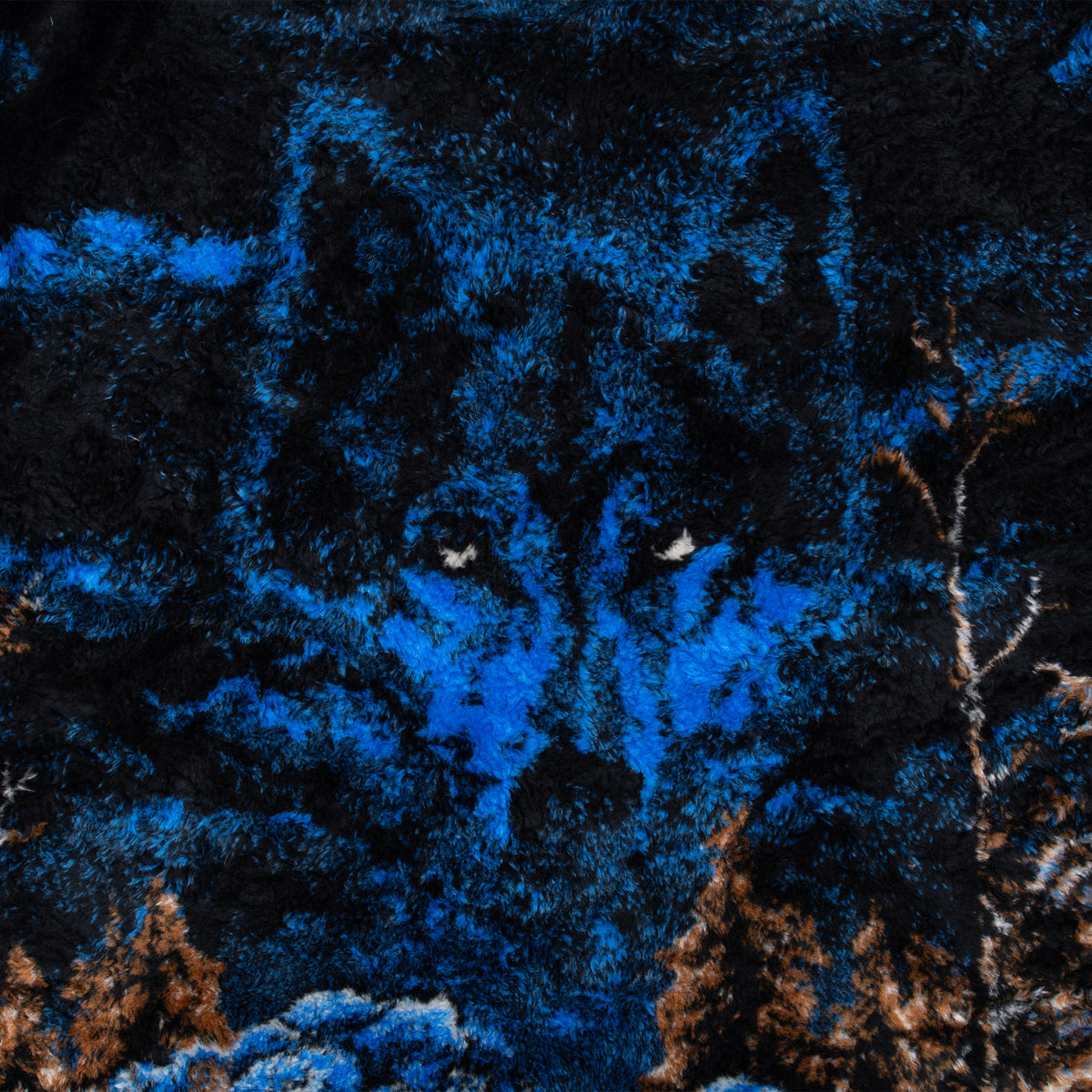 Close-up of blue wolf face and forest print on black fleece