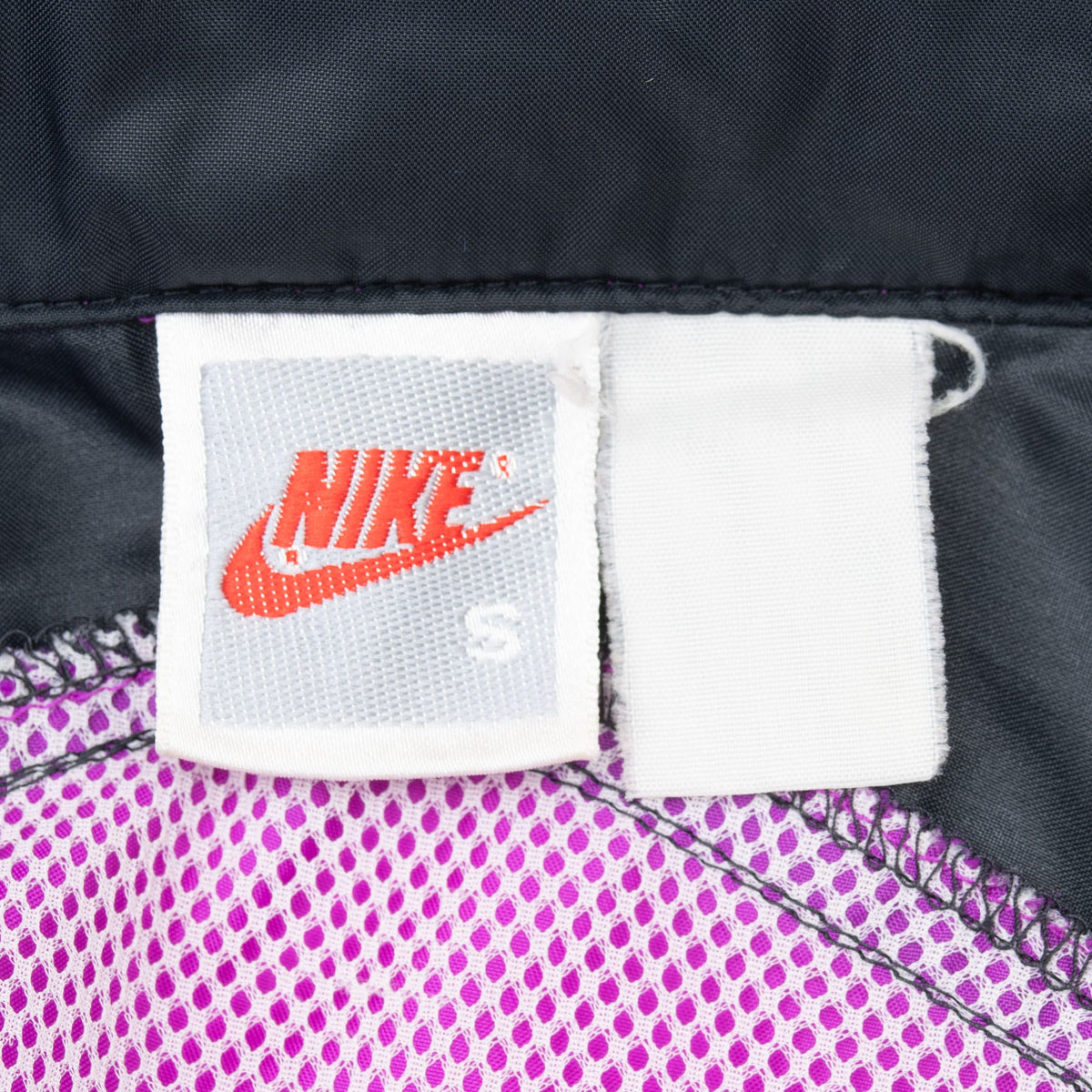 Nike size small neck label above purple mesh lining