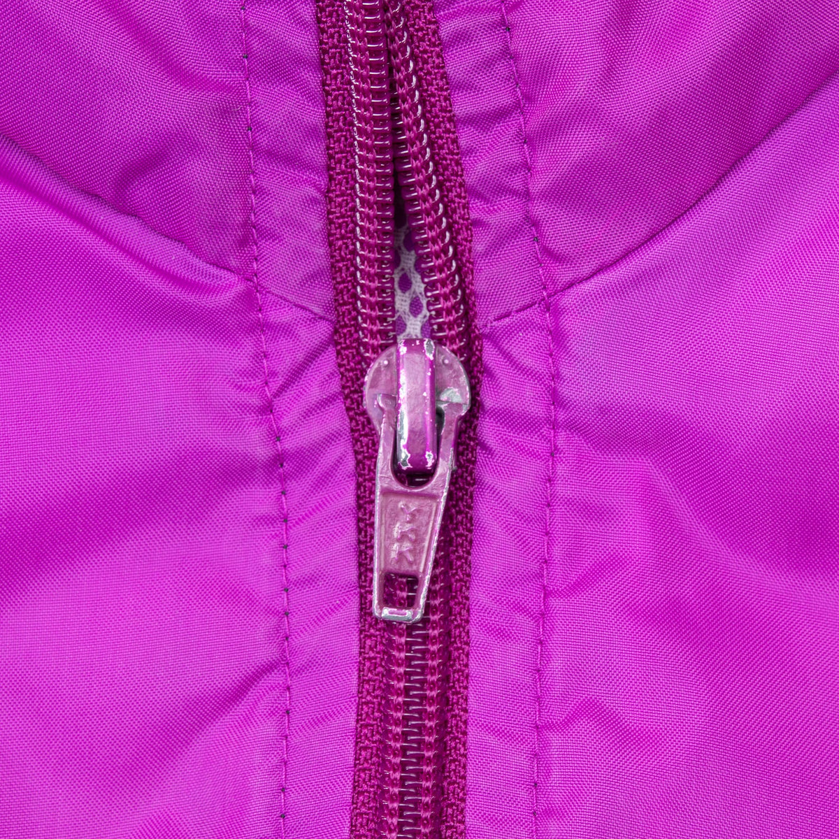 Close-up of purple front zipper and surrounding stitching