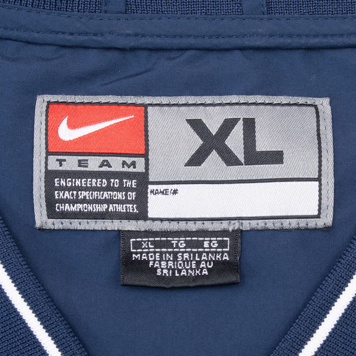 Close-up of Nike Team XL neck label inside navy Penn State pullover