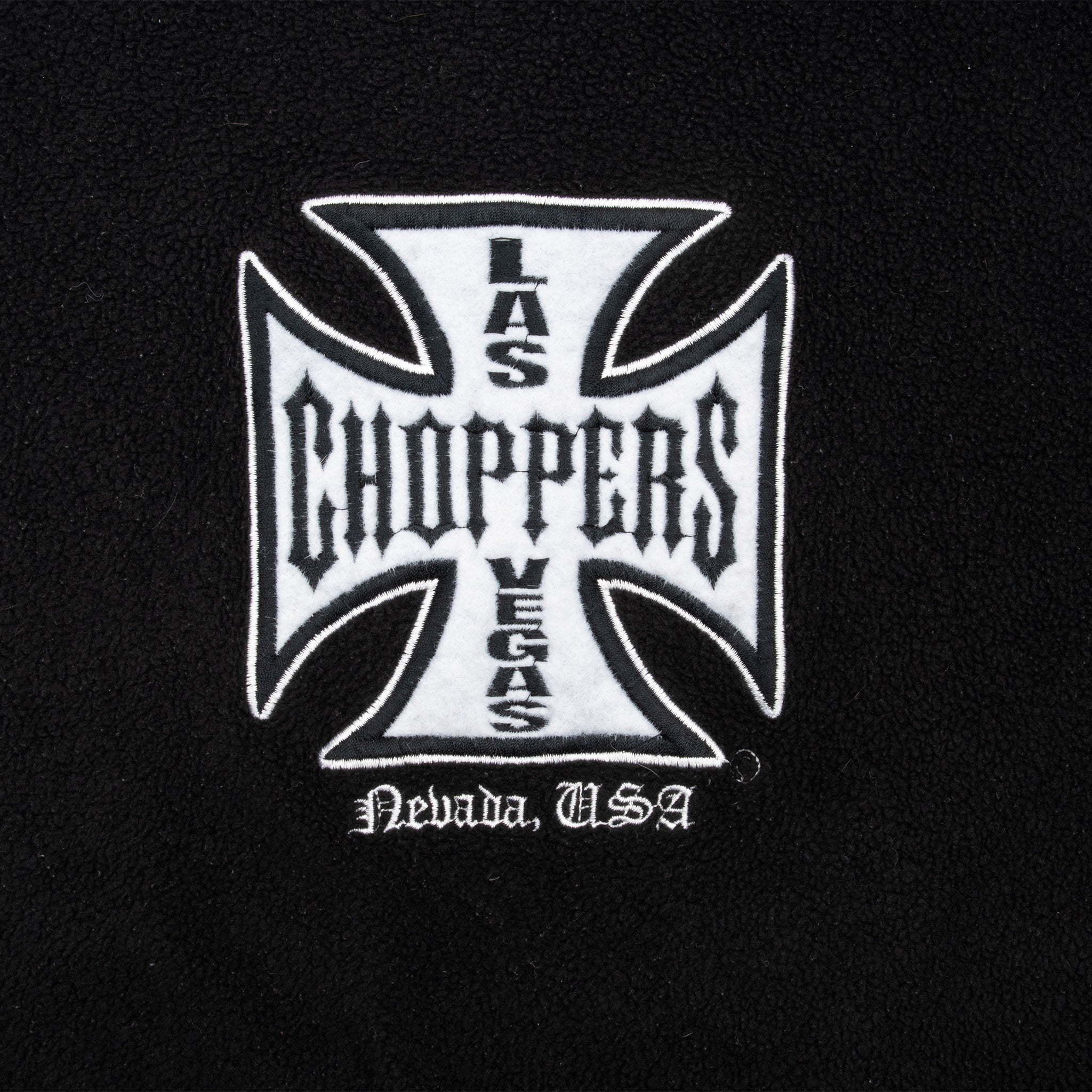 Close-up of white West Coast Choppers Las Vegas chest embroidery on black fleece