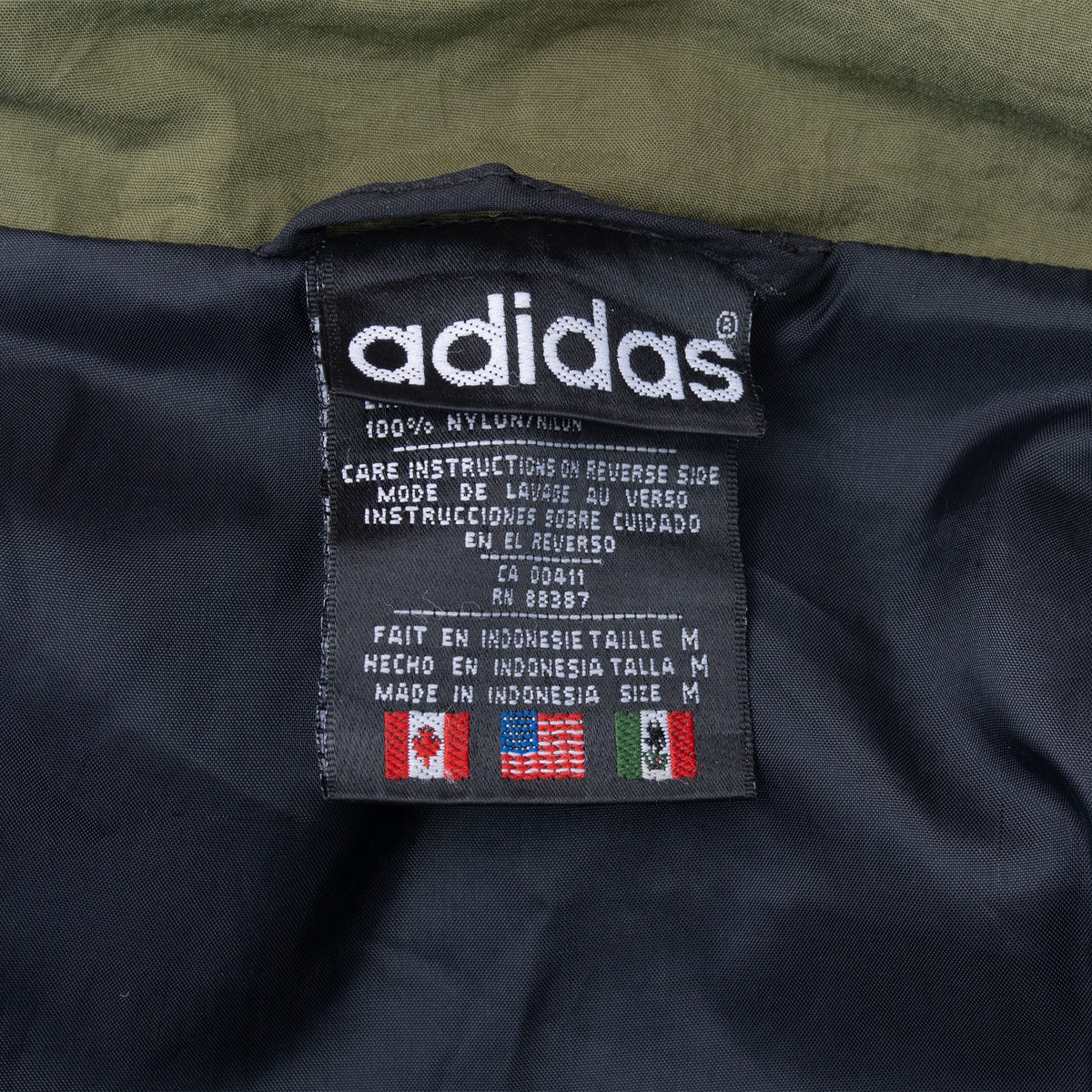 Adidas interior care label showing size M and made in Indonesia