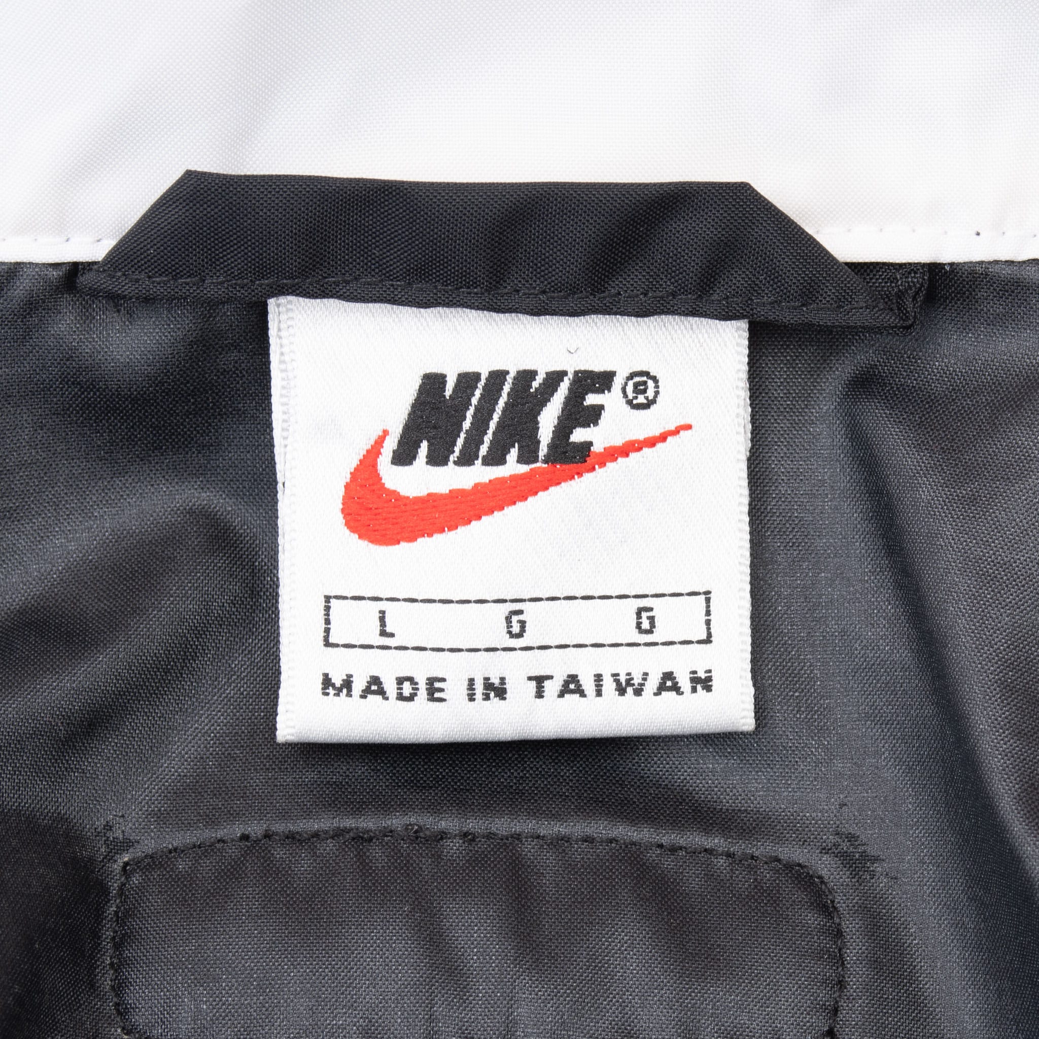 Close-up of Nike neck label marked size large and made in Taiwan