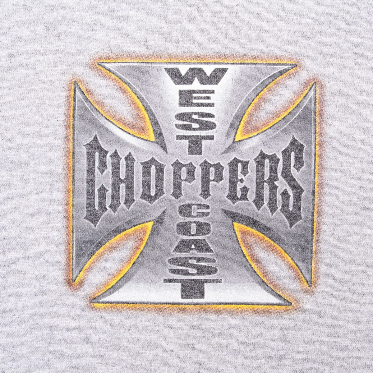 Close-up of West Coast Choppers cross-style chest print on gray fabric
