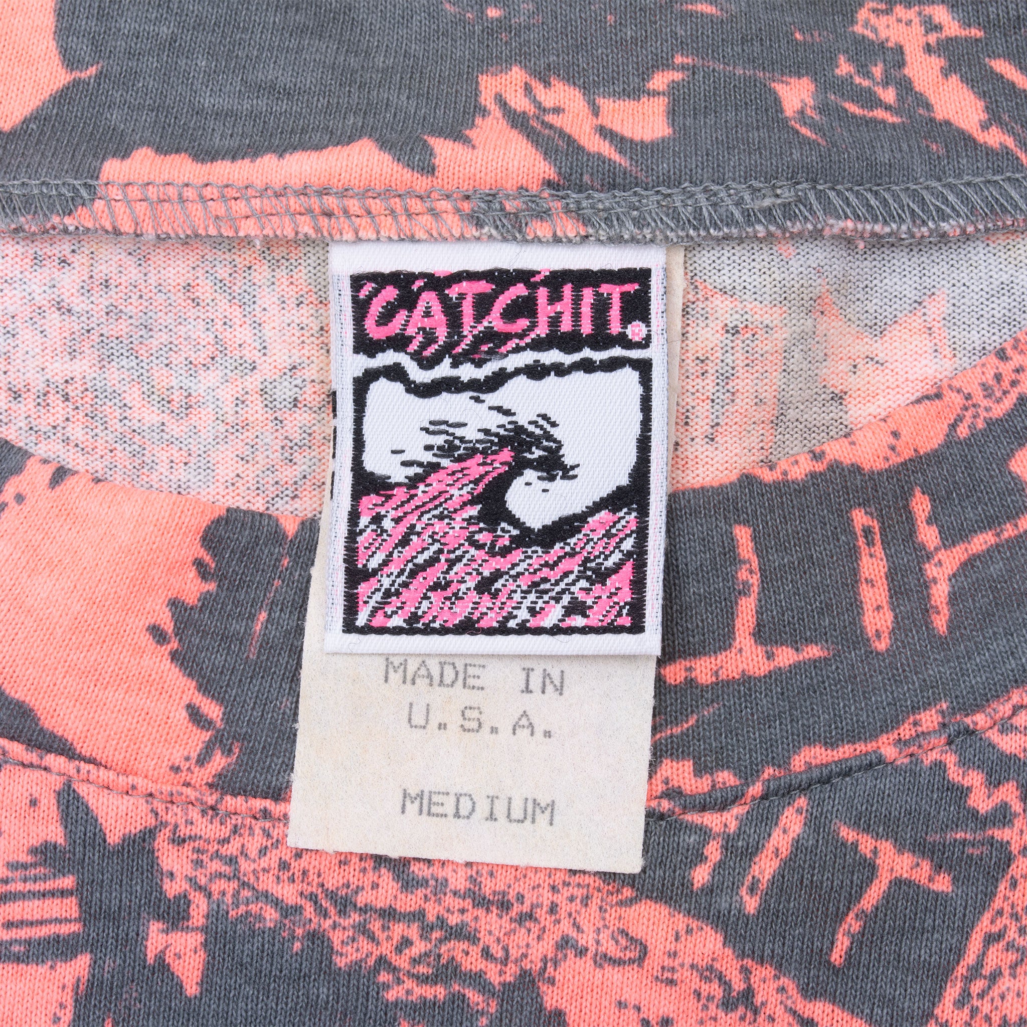 Catchit Surf neck label showing Made in USA and medium on pink and charcoal fabric