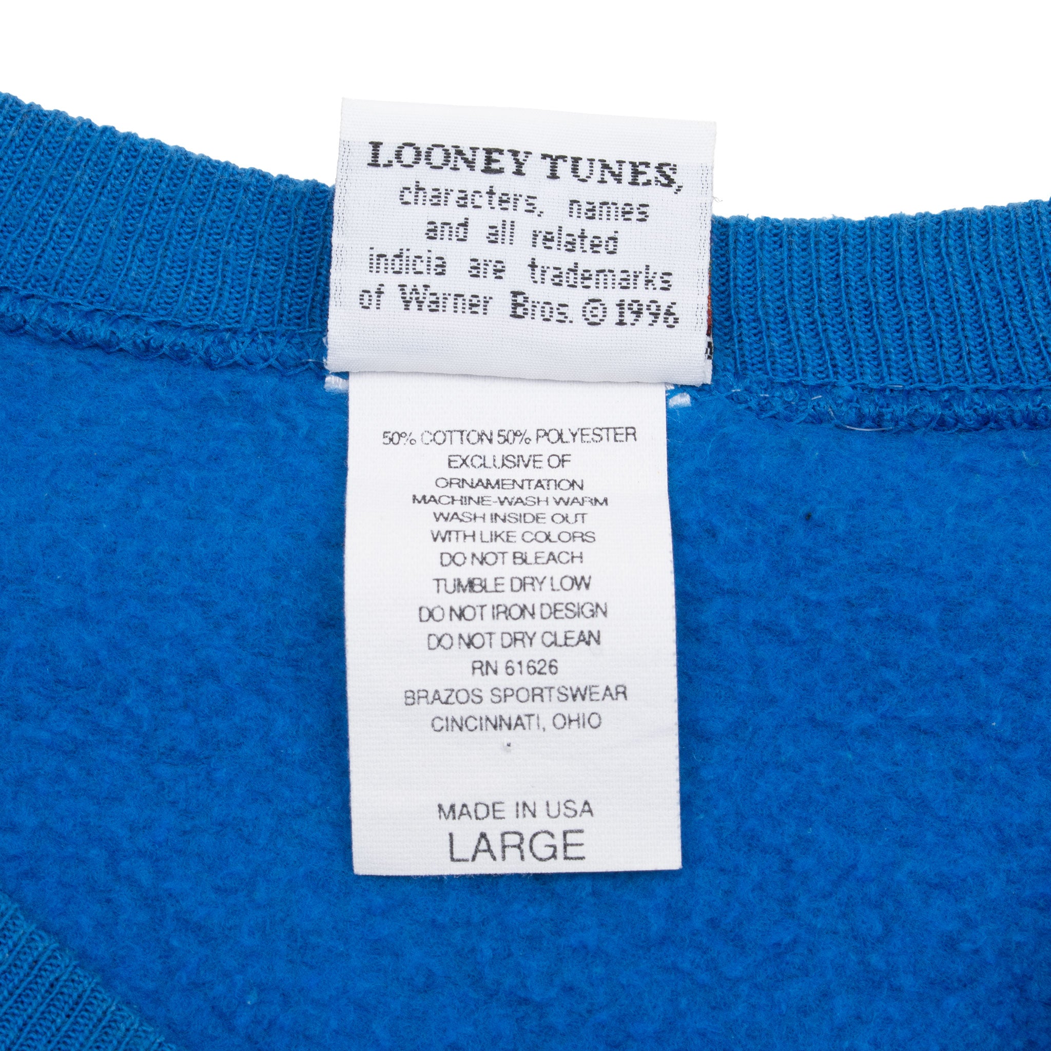 Looney Tunes copyright, fabric care, and large size labels