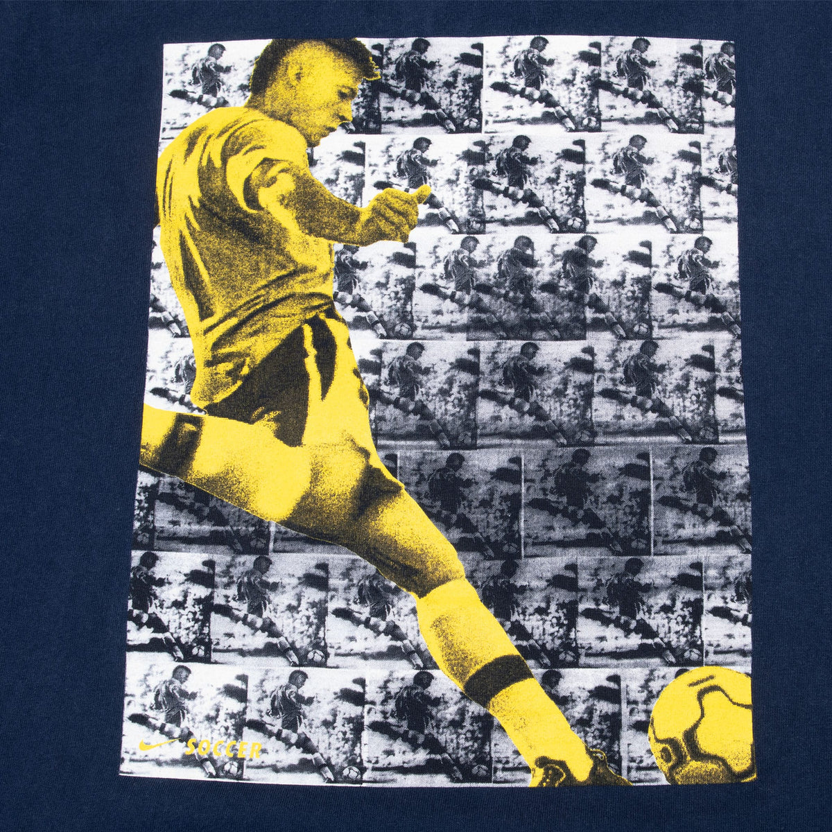 Close-up of back print featuring a yellow soccer player and ball over a photo collage