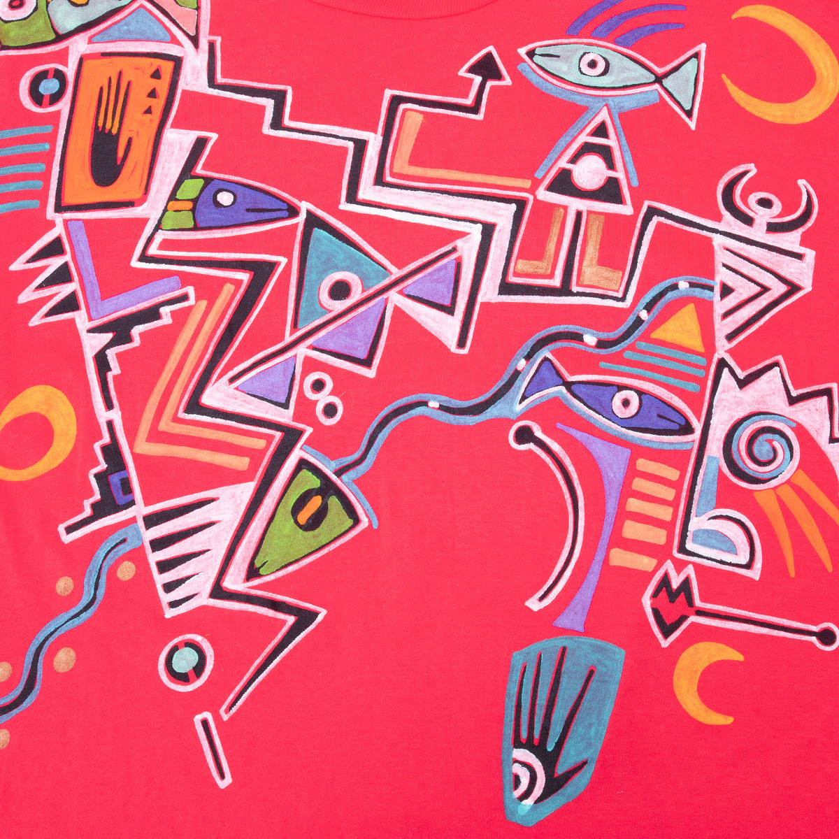 Close-up of colorful hand-painted geometric figures on front of red Elli T-shirt