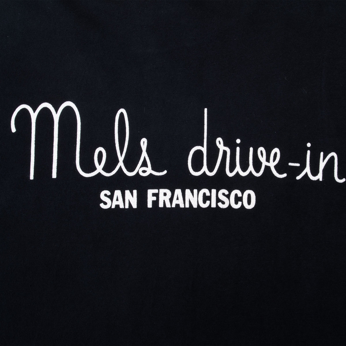 Close-up of white Mel's drive-in San Francisco back print on black fabric