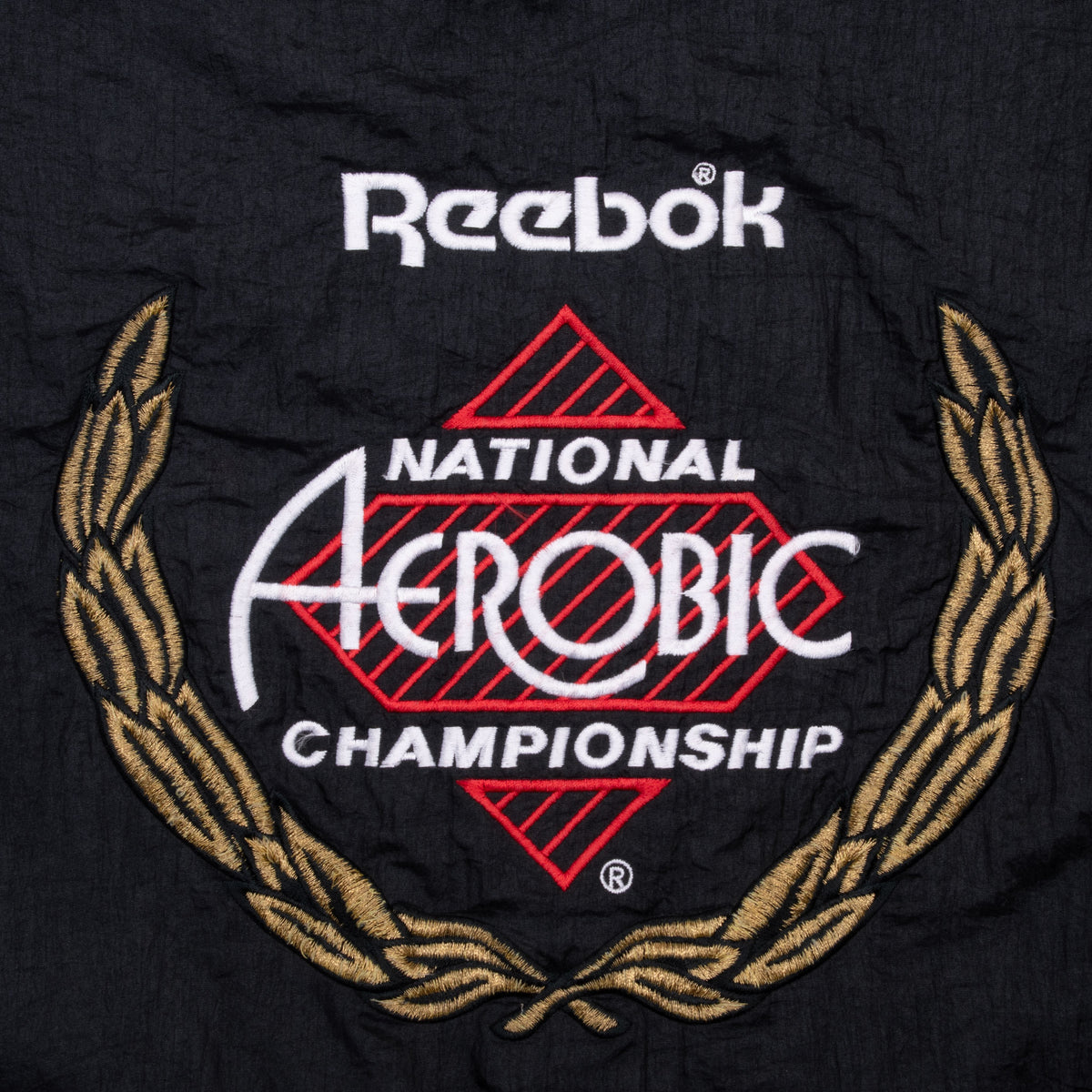 Close-up of Reebok National Aerobic Championship back graphic with gold laurel wreath