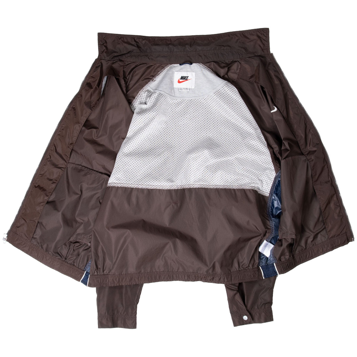 Open brown Nike windbreaker showing white mesh lining and interior label