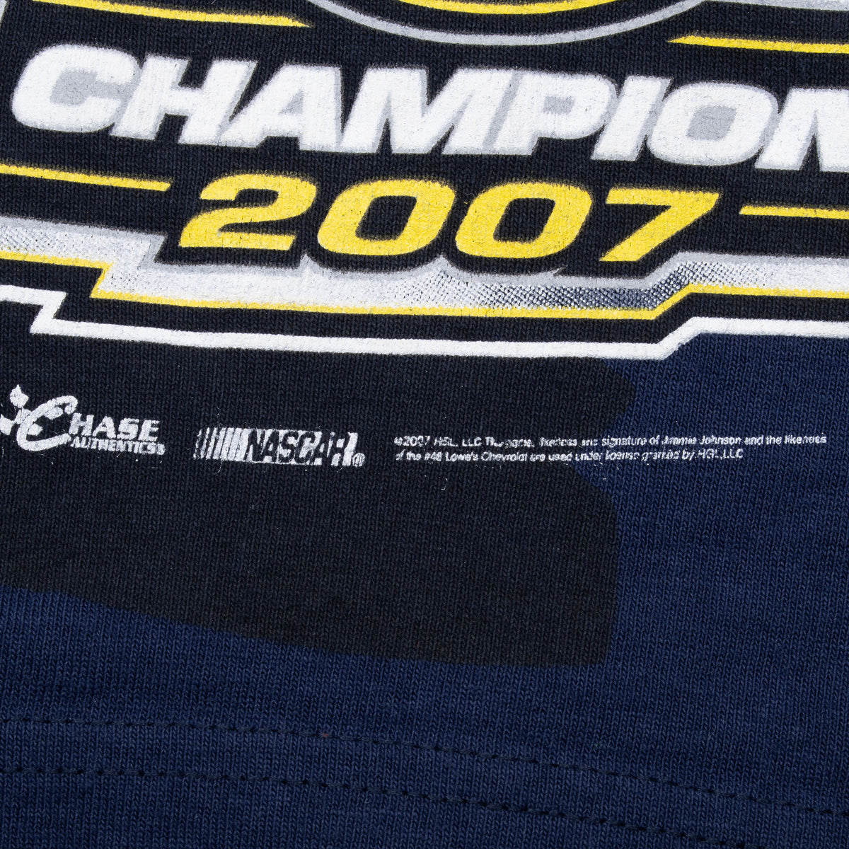 Champion 2007 graphic and Chase Authentics NASCAR copyright print near the tee hem