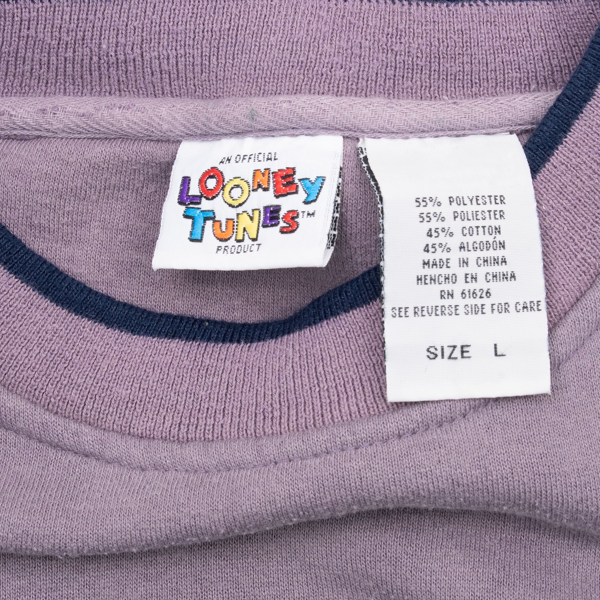 Looney Tunes neck label and size L care tag inside purple sweatshirt