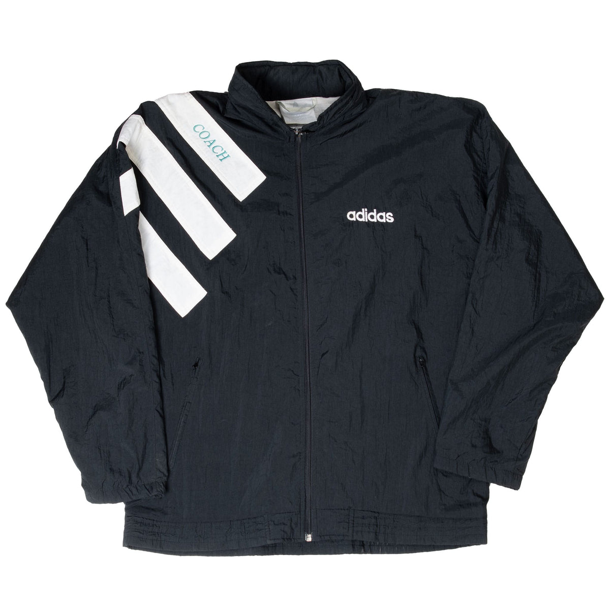 Front of black Adidas coach windbreaker with white stripes, chest logo, and zip pockets