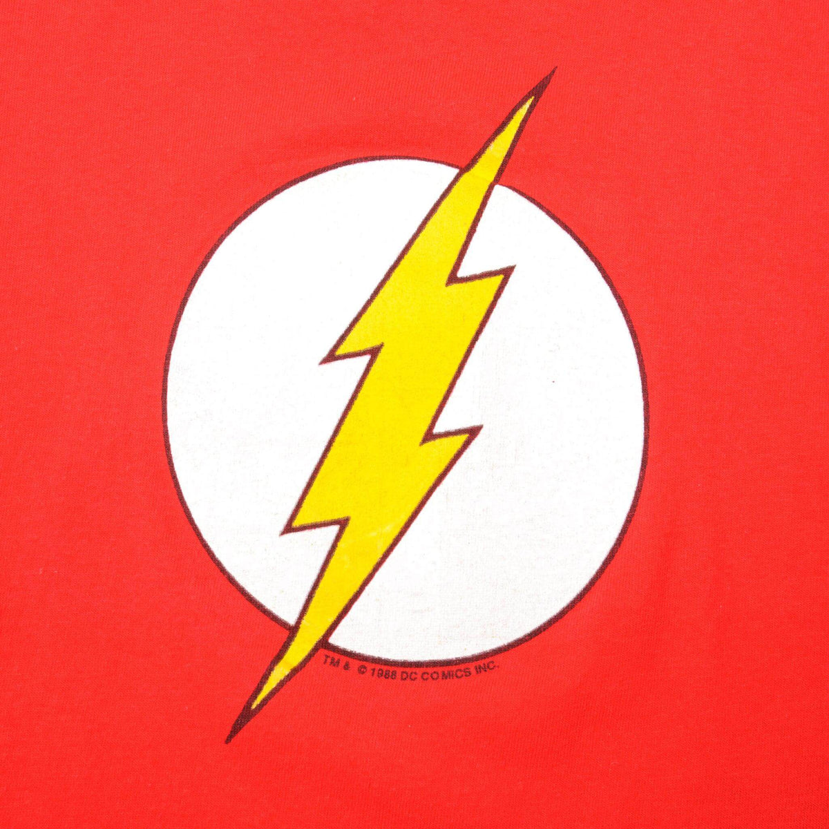 Close-up of yellow lightning bolt and white circle graphic on red The Flash T-shirt