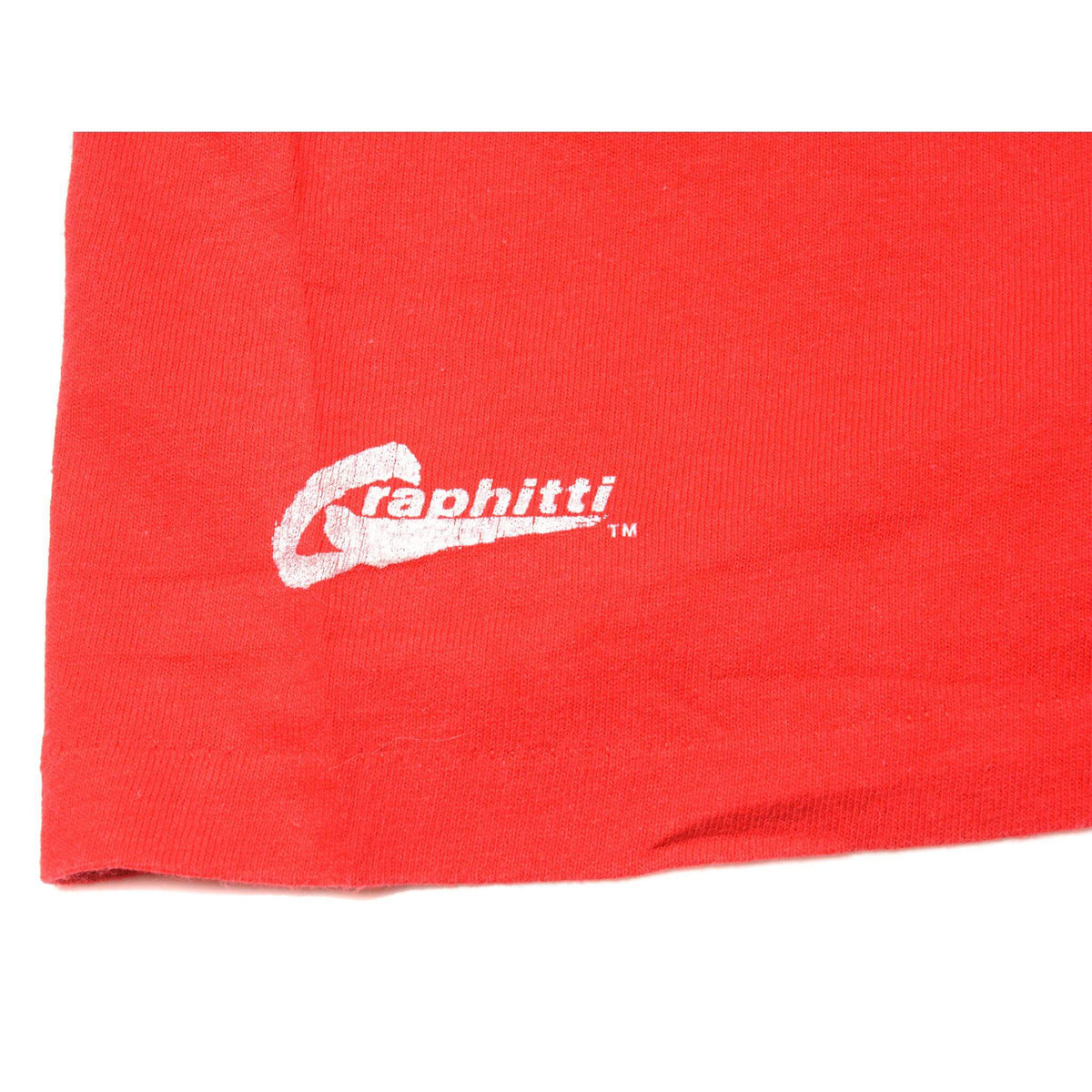 Close-up of white Graphitti logo printed on red T-shirt sleeve