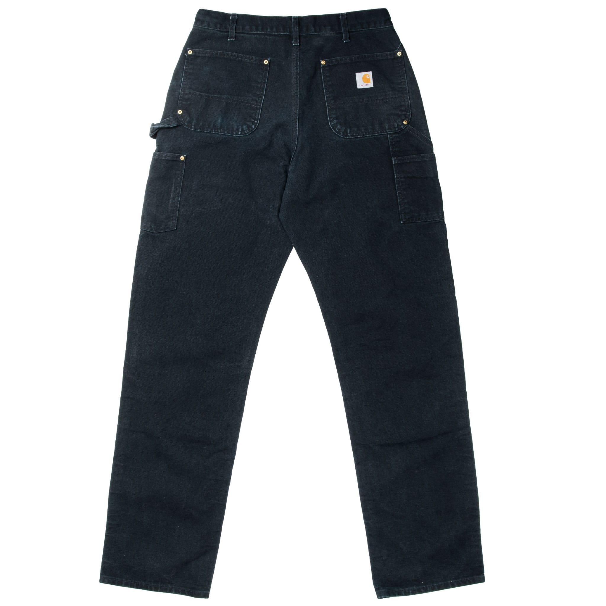 Back of black Carhartt carpenter pants with utility pockets, hammer loop, and logo patch