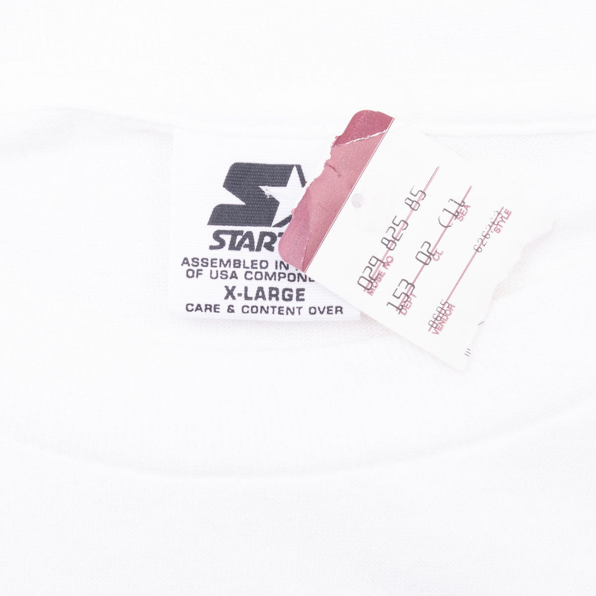 Close-up of Starter XL neck label and attached paper tag on white T-shirt