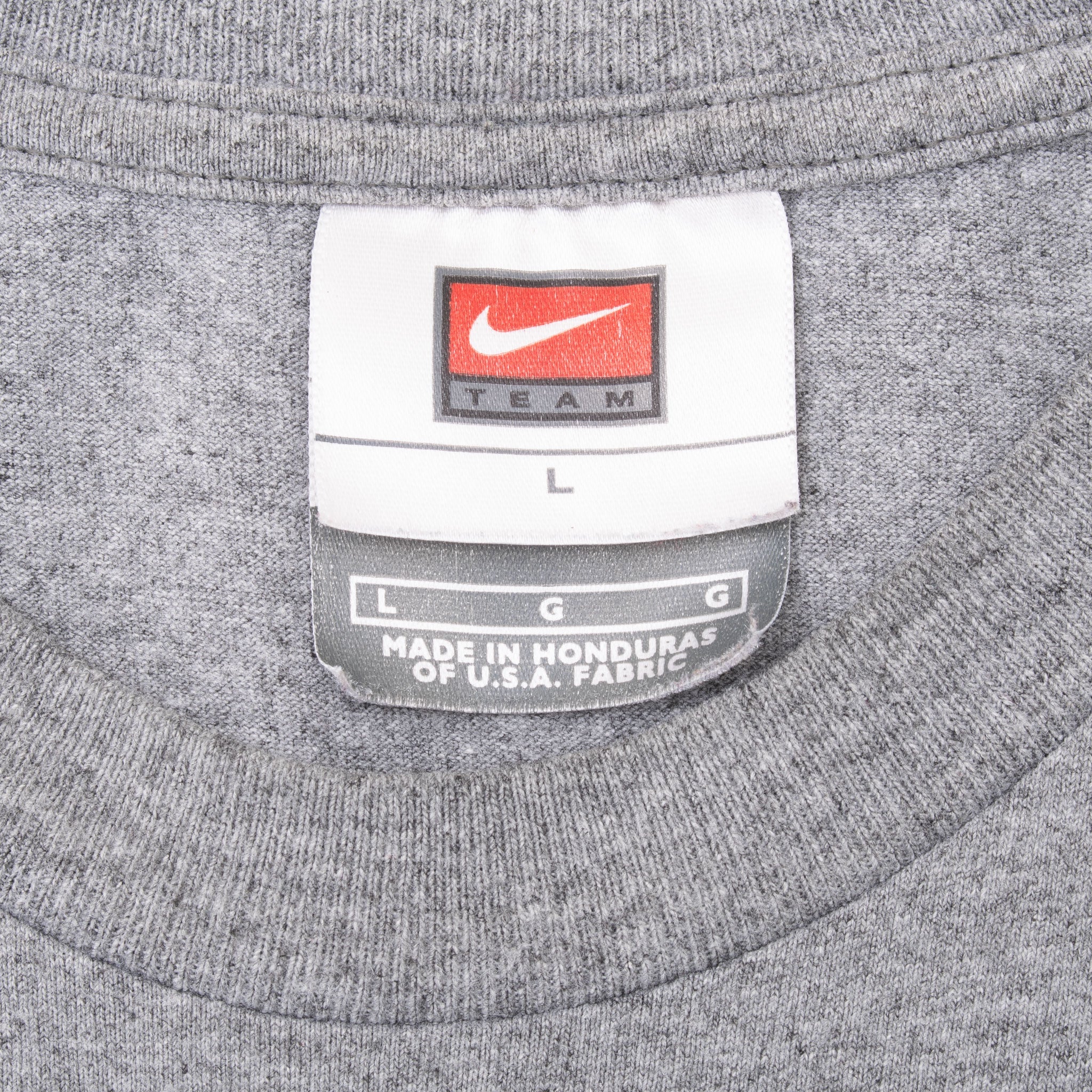 Close-up of Nike Team size large neck tag on grey T-shirt