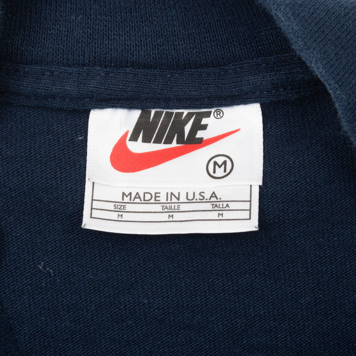 Nike neck tag showing medium size and Made in U.S.A.