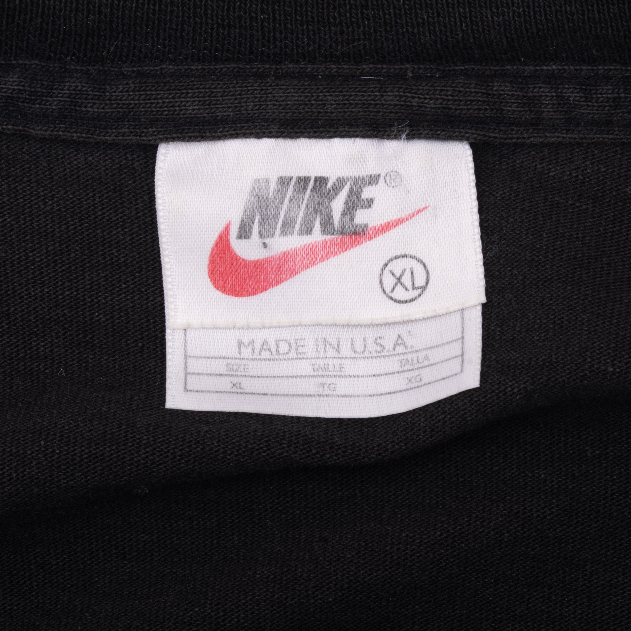 Nike neck tag showing Swoosh logo, XL size and Made in USA text