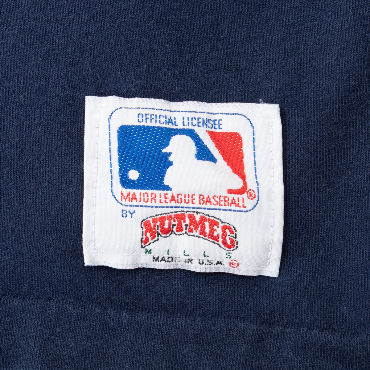 Close-up of MLB official license and Nutmeg Made in USA hem label