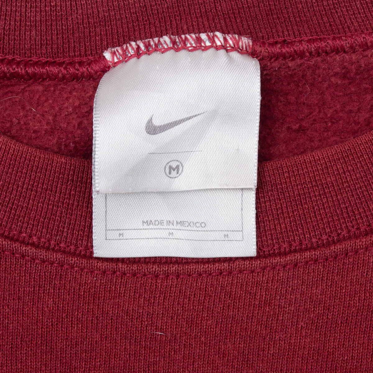 Nike neck tag showing Swoosh logo and medium size marking