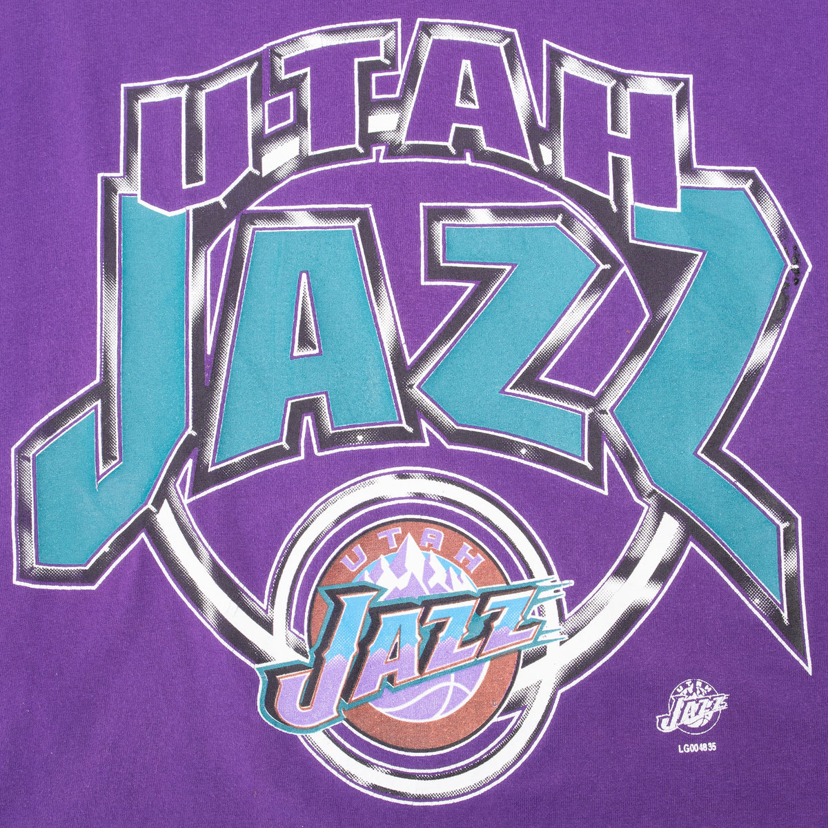 Close-up of teal, black, and white Utah Jazz front graphic on purple T-shirt