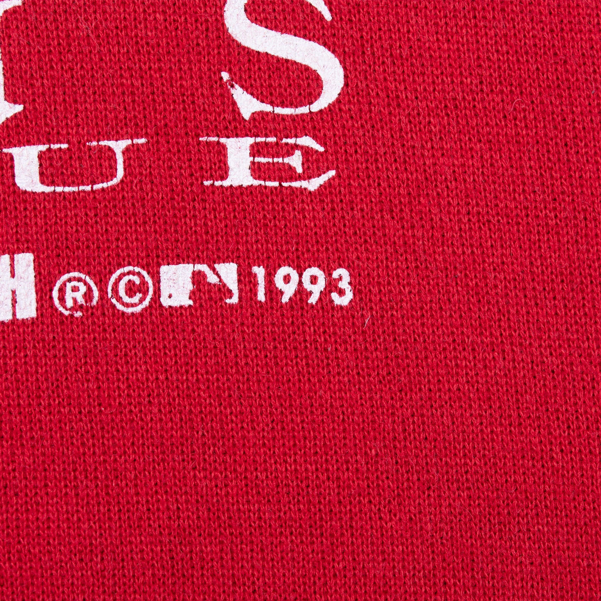 Close-up of MLB 1993 copyright mark printed on red hoodie fabric
