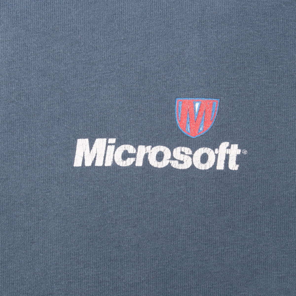 Close-up of white Microsoft chest logo with red and blue shield