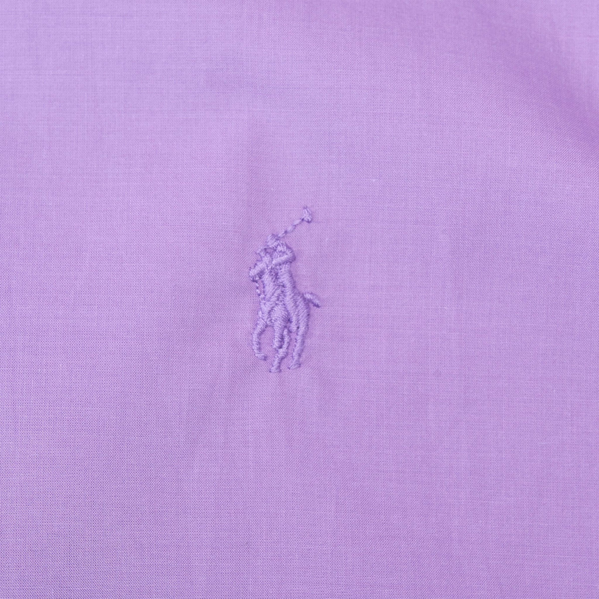 Close-up of tonal Polo pony embroidery on purple shirt chest