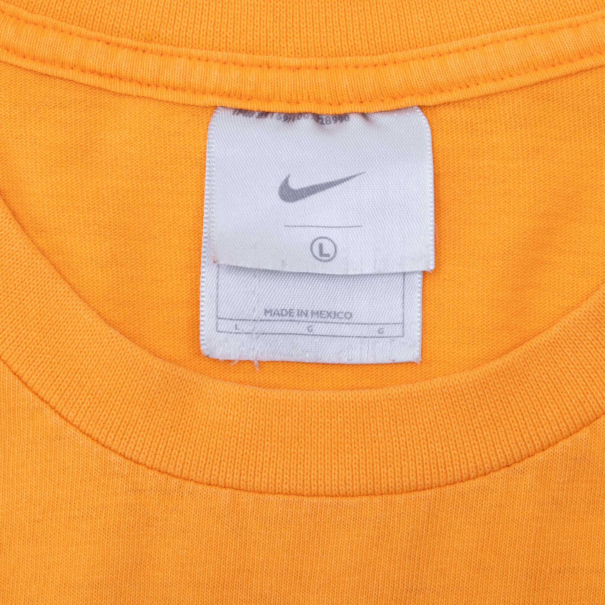 Nike neck tag with Swoosh and large size marking inside orange T-shirt