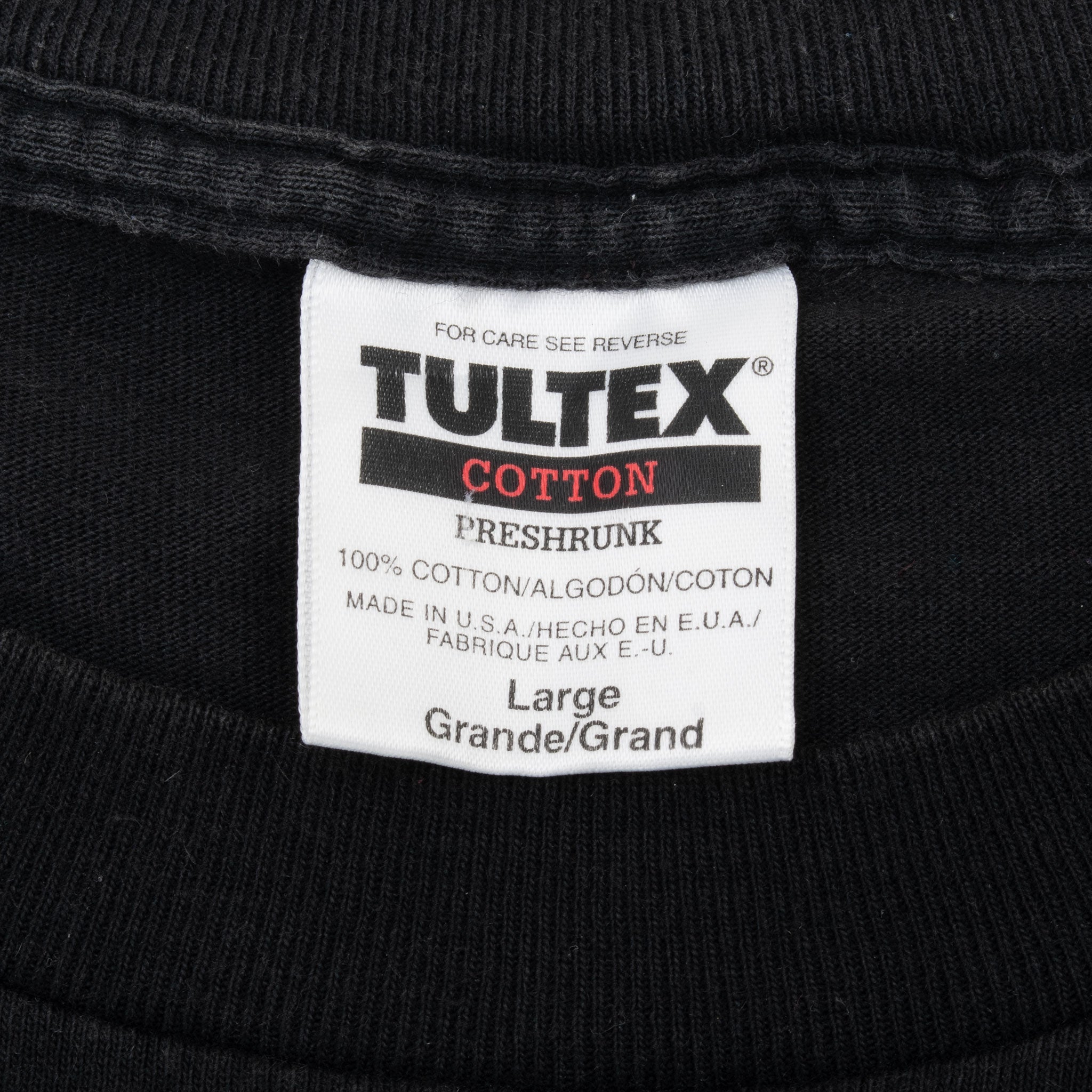 Close-up of Tultex cotton preshrunk neck label marked Large and made in USA