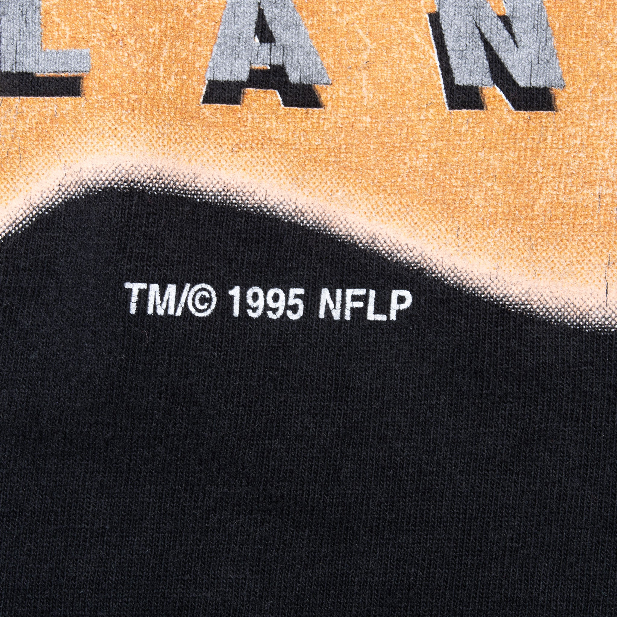 Close-up of TM/© 1995 NFLP copyright text beneath the front print