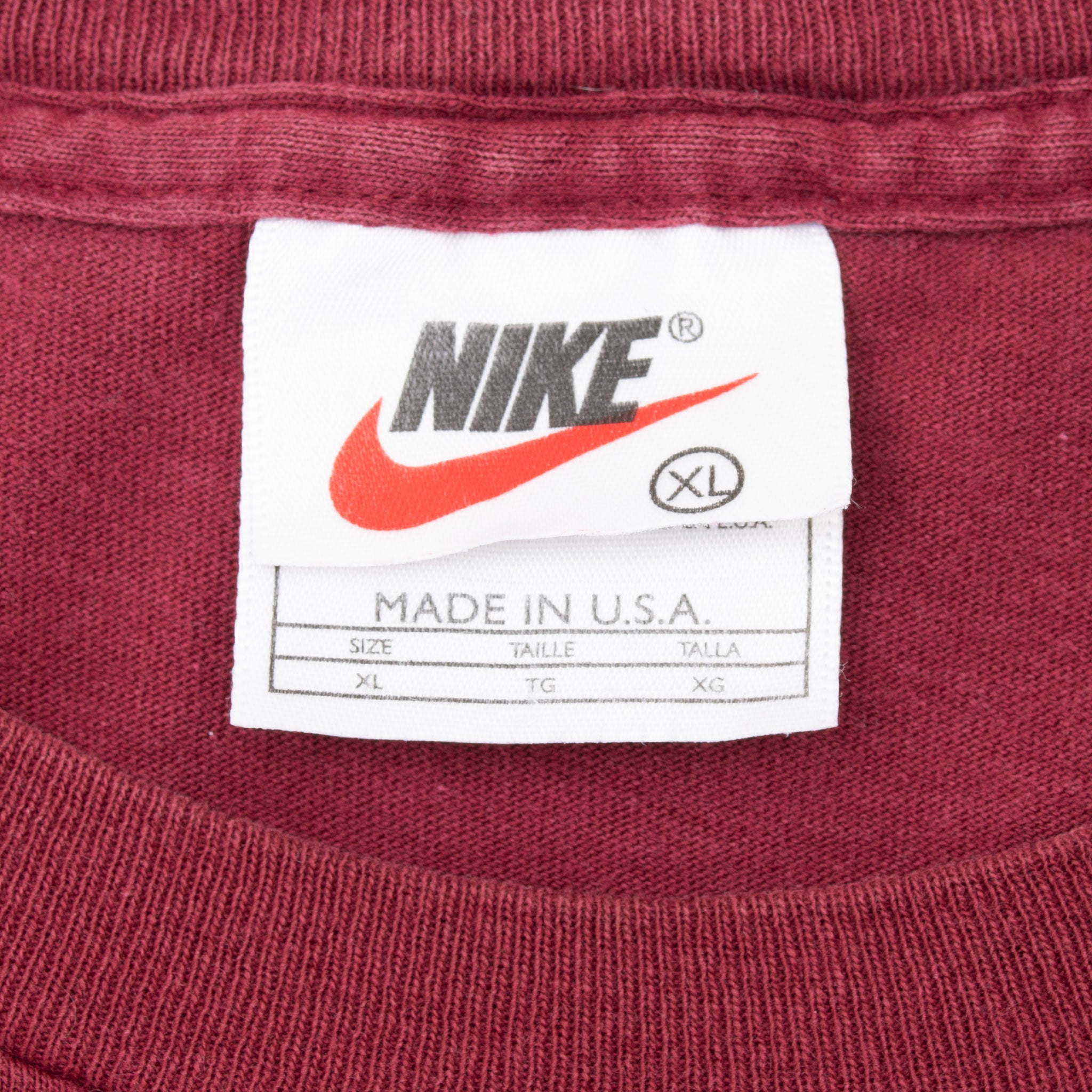 Nike neck tag marked XL and Made in U.S.A. inside burgundy T-shirt